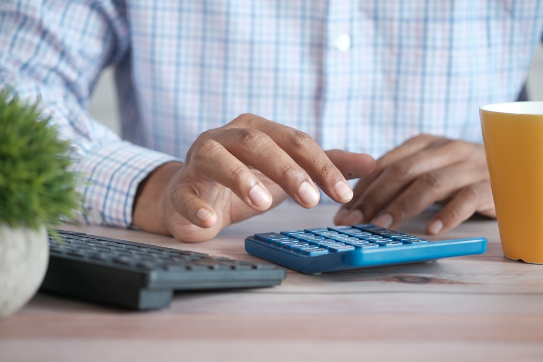 Person using a calculator for financial planning