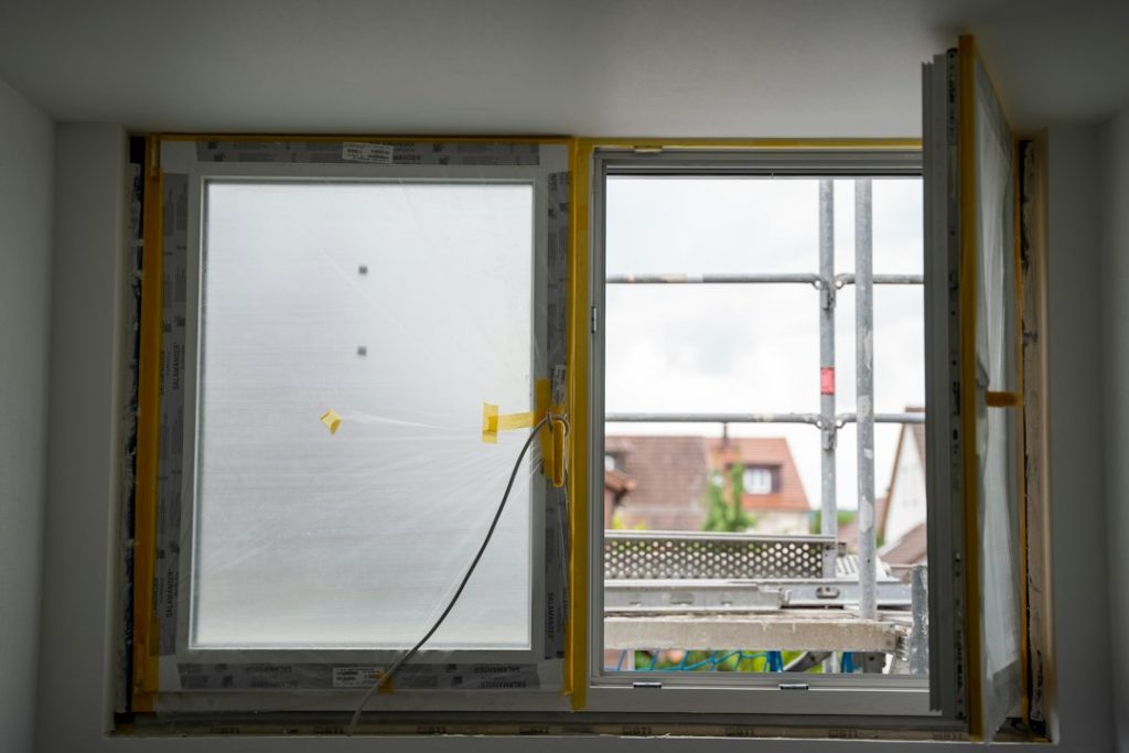 Replacement window under installation for draft and air leak guide