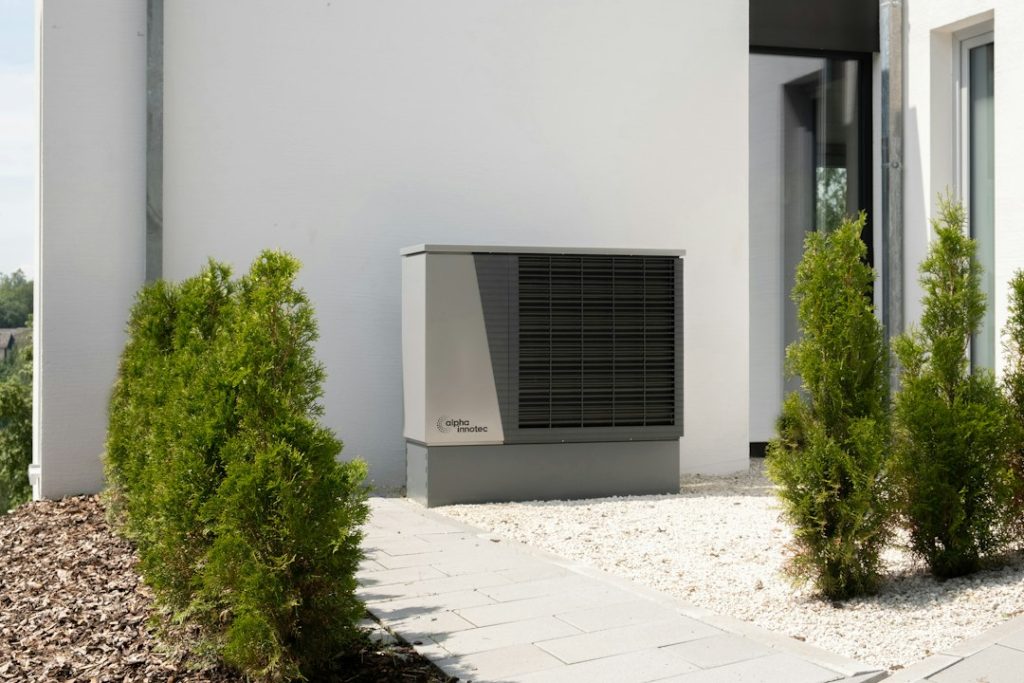 Residential outdoor heat pump unit beside a home