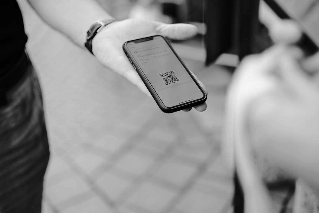 Person holding a smartphone while making a mobile payment