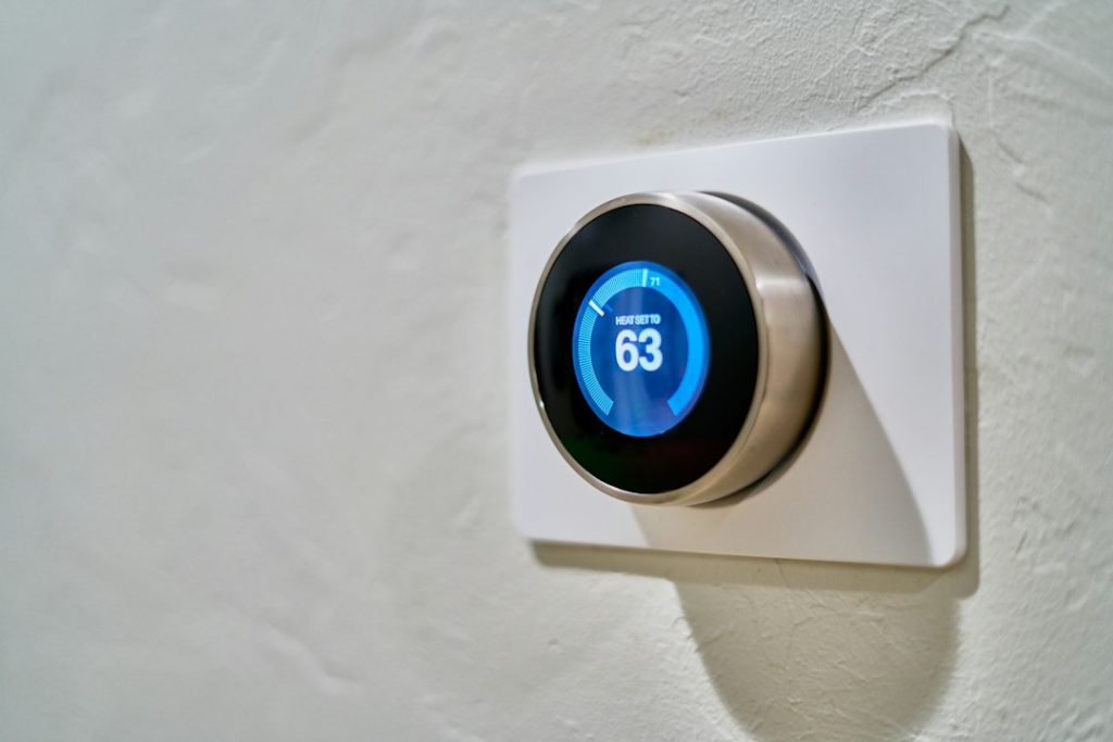 Digital thermostat mounted on a wall