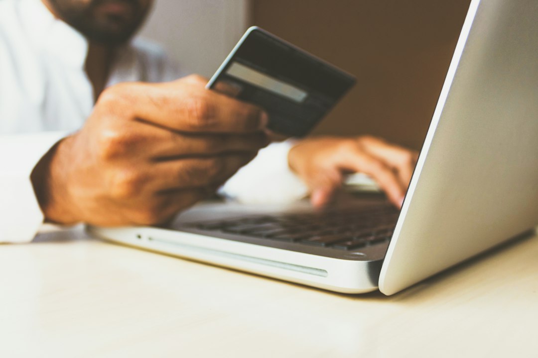 Person using a credit card for an online purchase